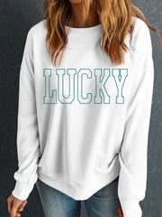 White sweatshirt with green varsity "LUCKY" graphic.