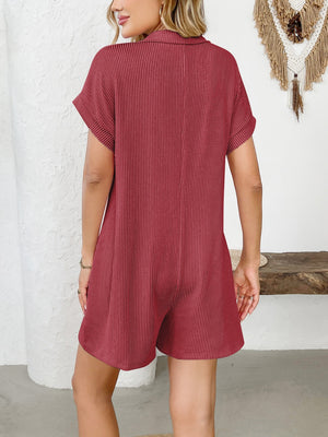 Scarlet ribbed knit romper with short sleeves, collar, and button detail.