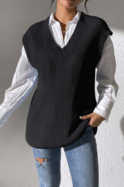 Black textured knit V-neck sleeveless vest over a white button-down shirt.