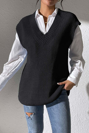 Black textured knit V-neck sleeveless vest over a white button-down shirt.