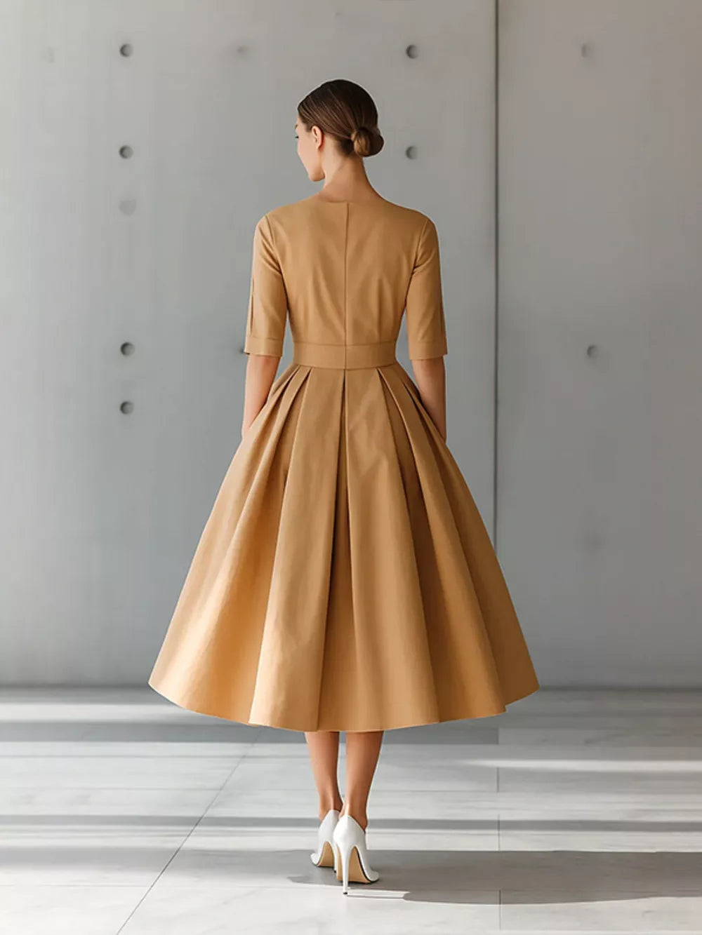 Camel A-line midi dress with pleated skirt and three-quarter sleeves.