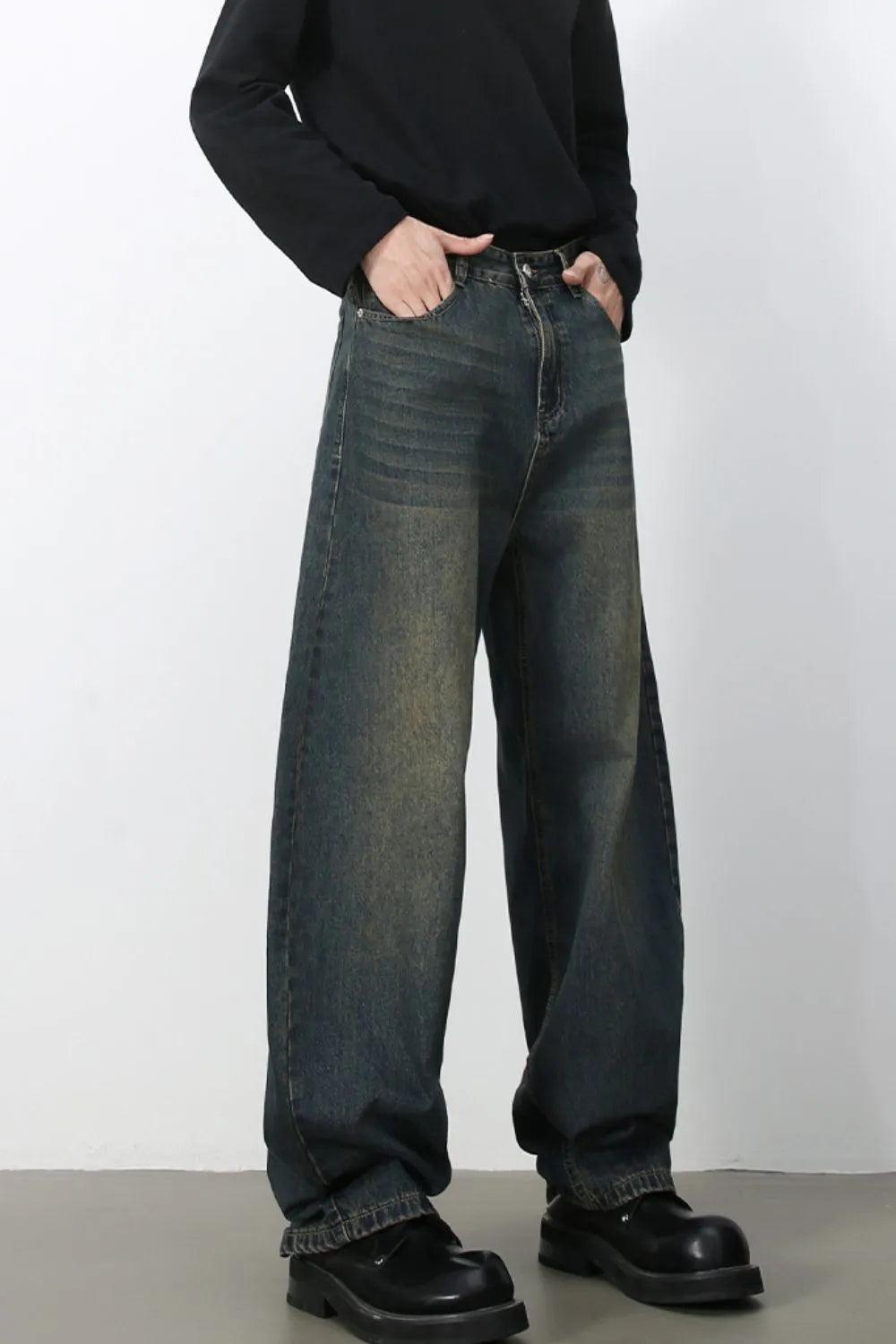Faded baggy denim jeans in a dark blue wash with a relaxed fit.