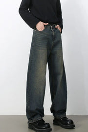 Faded baggy denim jeans in a dark blue wash with a relaxed fit.