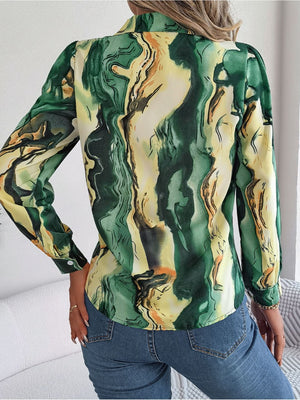 Women's abstract swirl print silk blouse in green and yellow with button cuffs.
