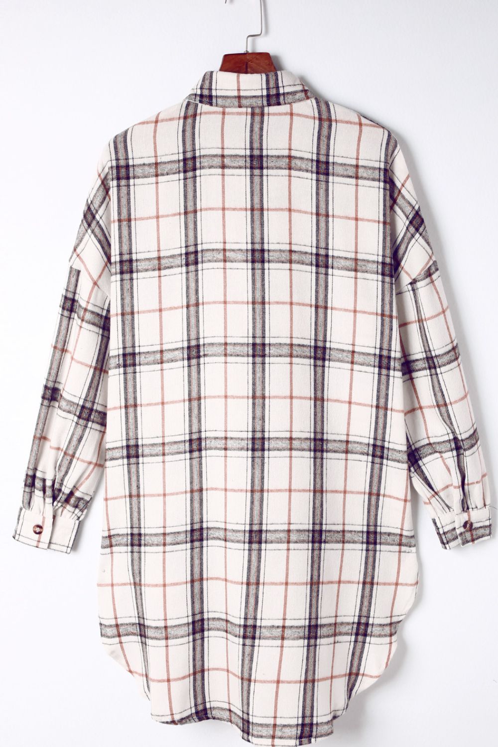Oversized white plaid shacket with a collared neckline and button cuffs.