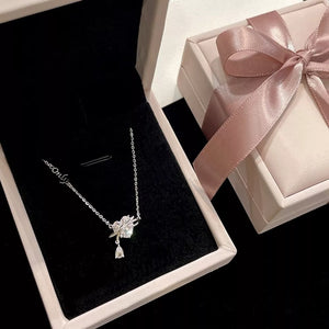 Elegant silver necklace with a delicate zircon heart pendant and teardrop charm.