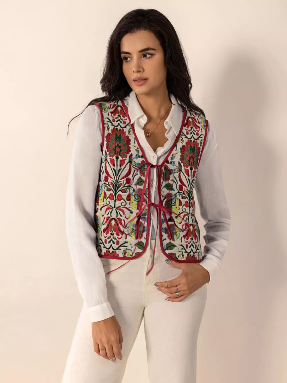 Embroidered tie-front cropped vest coat in deep red with floral pattern, trimmed in red.