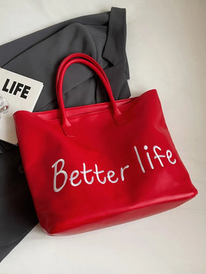 Red tote bag with metallic "Better Life" graphic and twin handles.