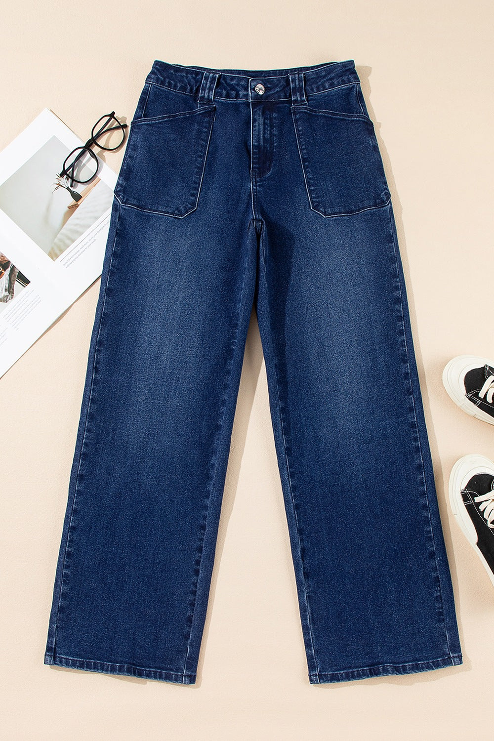 Mid-rise straight leg jeans in dark wash denim with button closure and large front pockets.