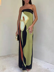 Strapless maxi gown with abstract floral print in green, black, and rust.