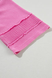 Waffle knit top in fuchsia pink with raw seam detail and textured stripe panel.