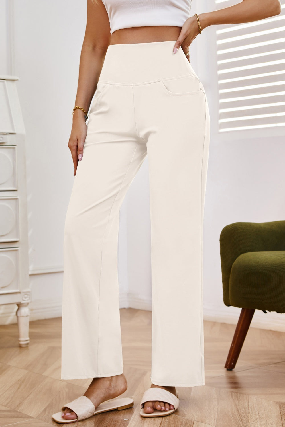 High-waisted flare leg trousers in white with a comfortable fit and subtle pocket detail.