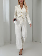 Beige vertical stripe button-down jumpsuit with tie waist and v-neck.