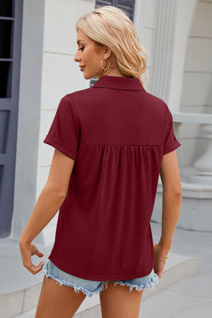Burgundy short sleeve polo top with gathered yoke detail and cuffed sleeves.