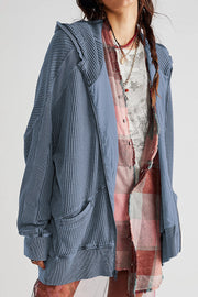 Waffle knit hooded zip-through jacket in blue with contrast panels and pockets.