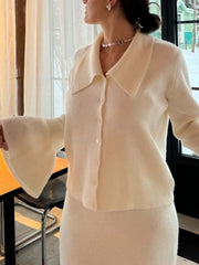 Milky white ribbed knit cardigan with bell sleeves and matching skirt.