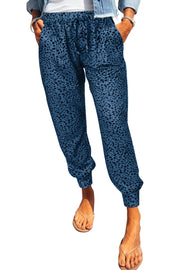 Peacock blue leopard print drawstring trousers with pockets and elastic cuffs.