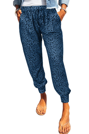 Peacock blue leopard print drawstring trousers with pockets and elastic cuffs.