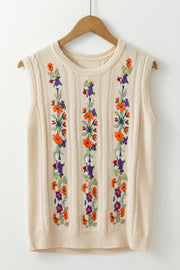 Beige cable knit vest with floral embroidery down the front.