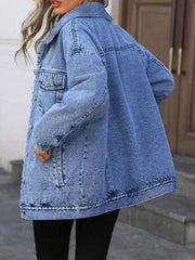 Oversized blue washed denim jacket with button pockets and collar.
