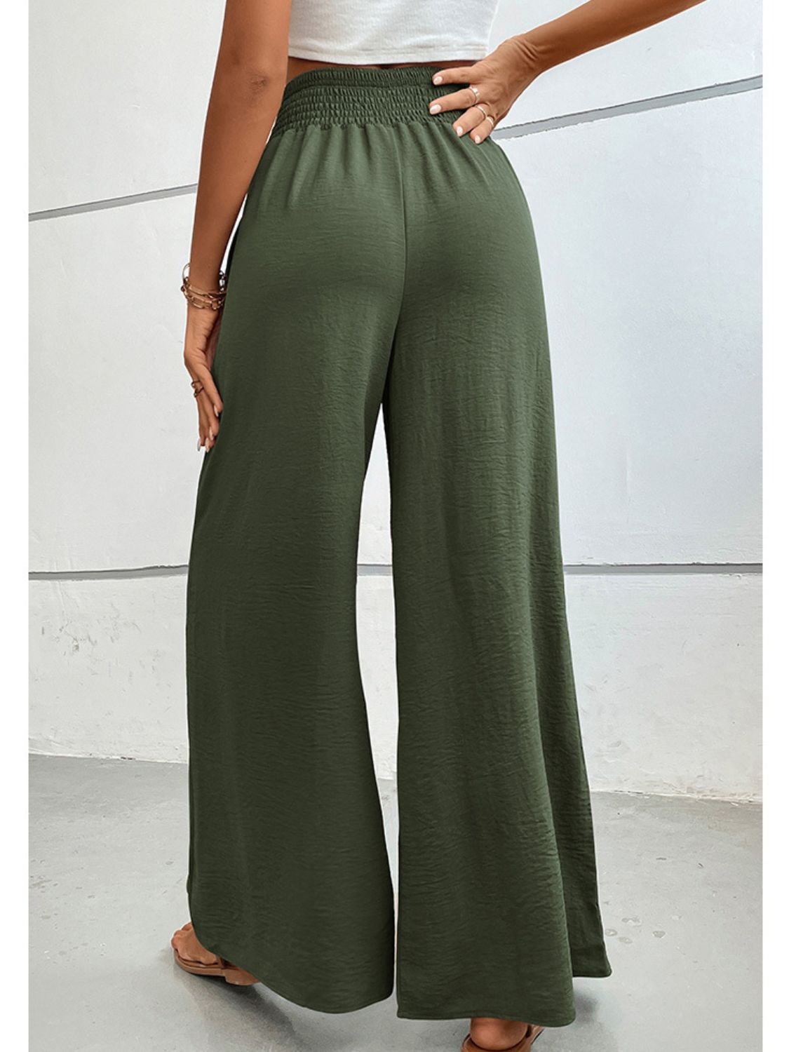 Textured smocked waist palazzo trousers in matcha green with wide legs.