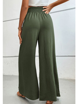 Textured smocked waist palazzo trousers in matcha green with wide legs.