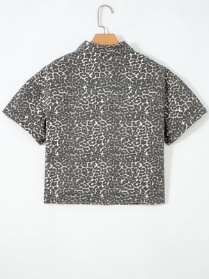 Denim short-sleeve shirt with leopard print, collared neckline, and button-up front.