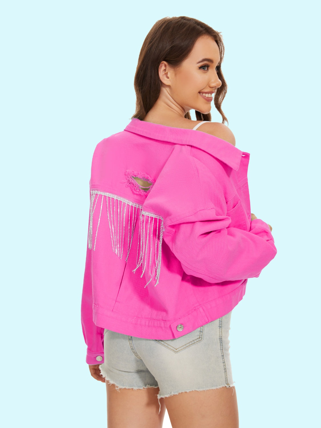 Hot pink denim trucker jacket with distressed back and crystal fringe detail.