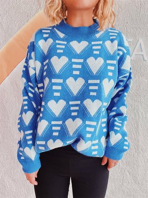 Blue acrylic knit jumper with white geometric heart pattern and mock neck.