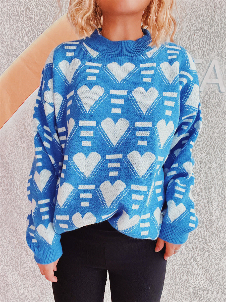 Blue acrylic knit jumper with white geometric heart pattern and mock neck.