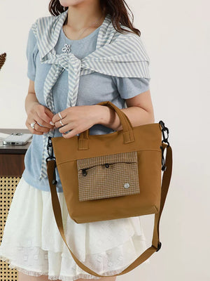 Plaid-detail nylon crossbody bag in brown with front pocket detail.