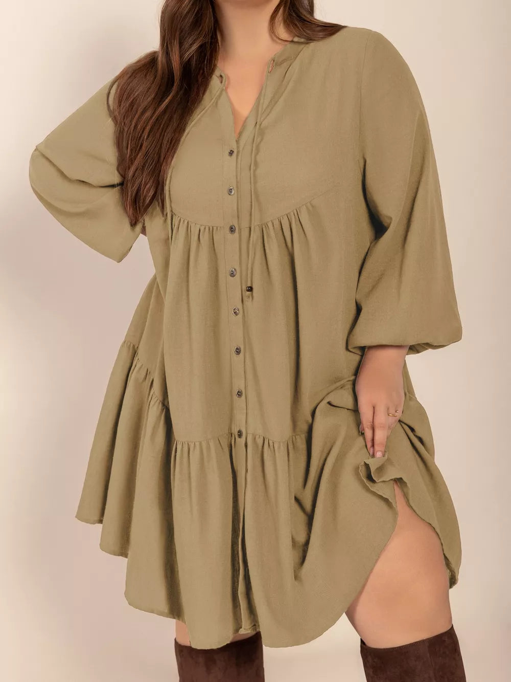 Olive green button-front tiered dress with balloon sleeves and tie-neck detail.