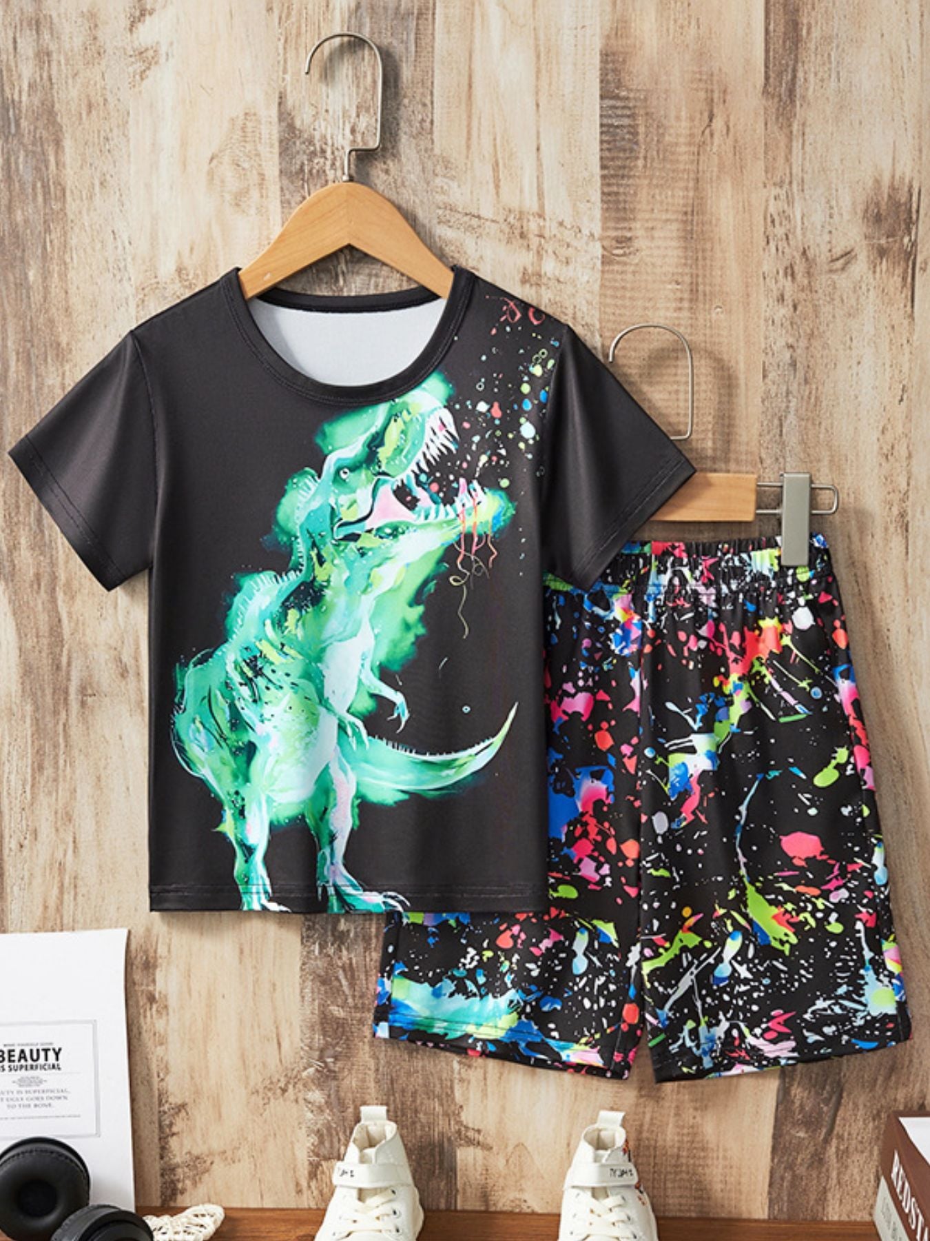 Black toddler two-piece set with green dinosaur print t-shirt and colorful paint splatter shorts