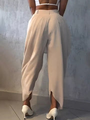 Light khaki sculptural pleated high-waisted pants with a wide leg and split hem.