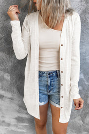 Ivory button-down maxi cardigan with long sleeves and brown buttons.