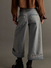 Light blue high-waisted cropped jeans with wide legs and cuffed hems.
