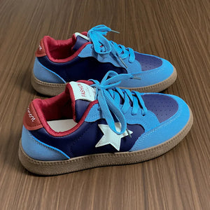 Blue retro sneakers with white star appliqué and contrast red lining.