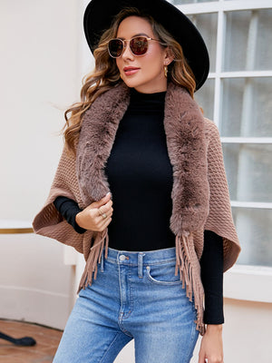 Textured knit poncho in Khaki with faux fur collar and fringe detail.