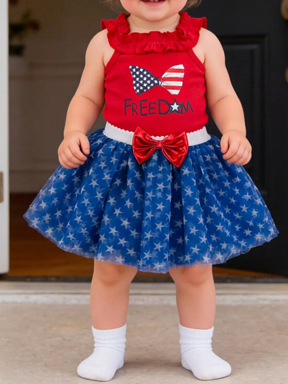 Baby girls' red tank top and blue star tulle skirt set with patriotic bow detail.