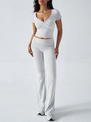 Light gray loungewear set with ruched waistband flared pants and a v-neck short sleeve top.