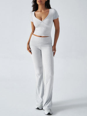 Light gray loungewear set with ruched waistband flared pants and a v-neck short sleeve top.