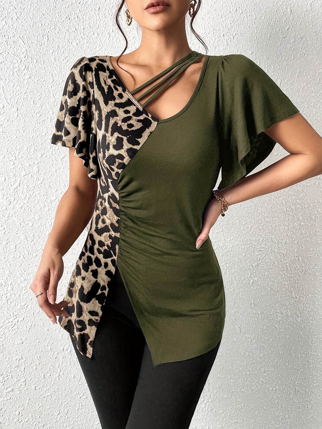 Asymmetric leopard paneled blouse in moss with cutout neckline and ruched side detail.