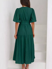Green midi dress with puff sleeves, elastic waist, and tiered skirt.