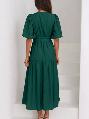 Green midi dress with puff sleeves, elastic waist, and tiered skirt.