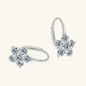 Silver celestial cluster huggie hoop earrings with star-shaped crystal details.