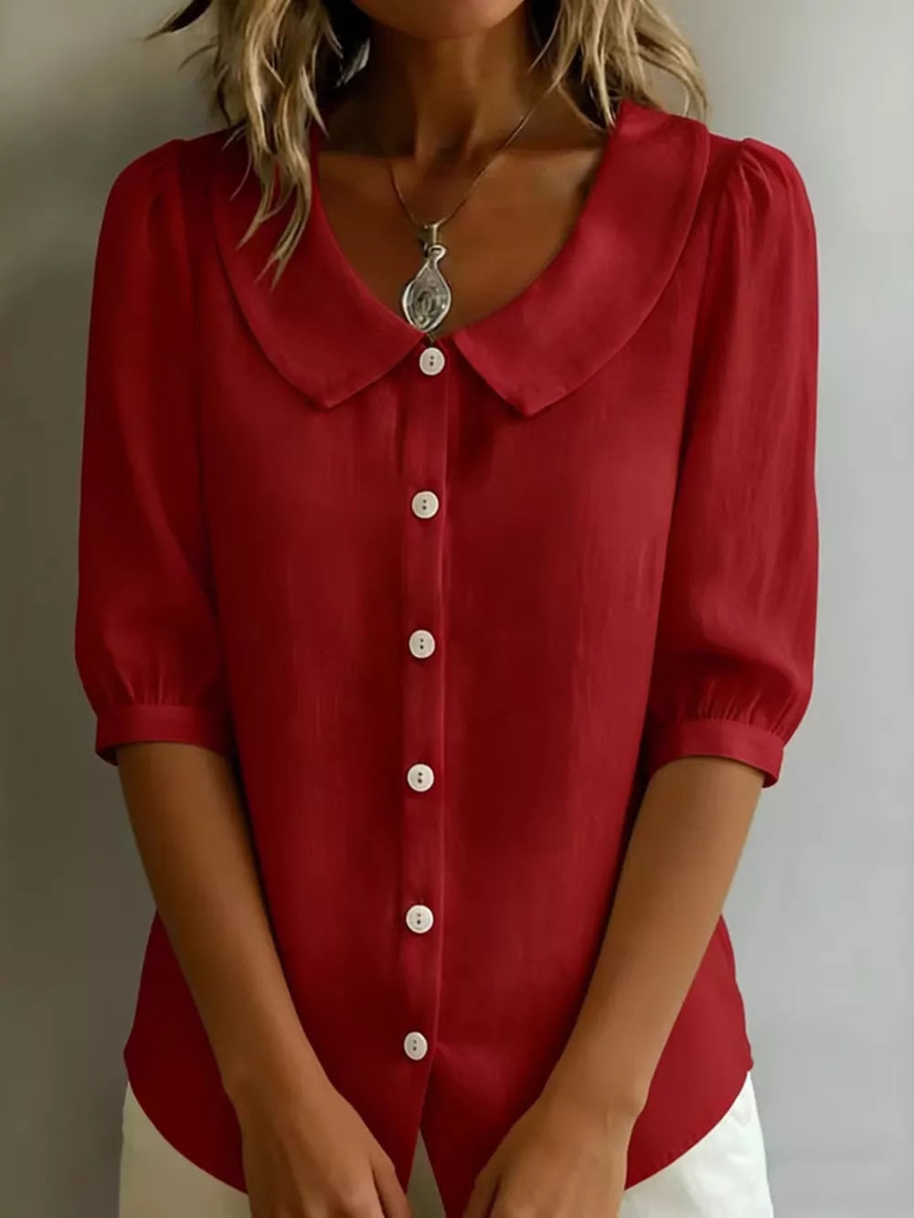 Deep Red puff sleeve shirt with Peter Pan collar and white buttons.
