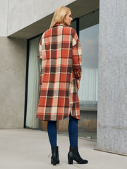 Oversized plaid shirt jacket dress in orange-red, brown, and cream, with button details and a long hem.