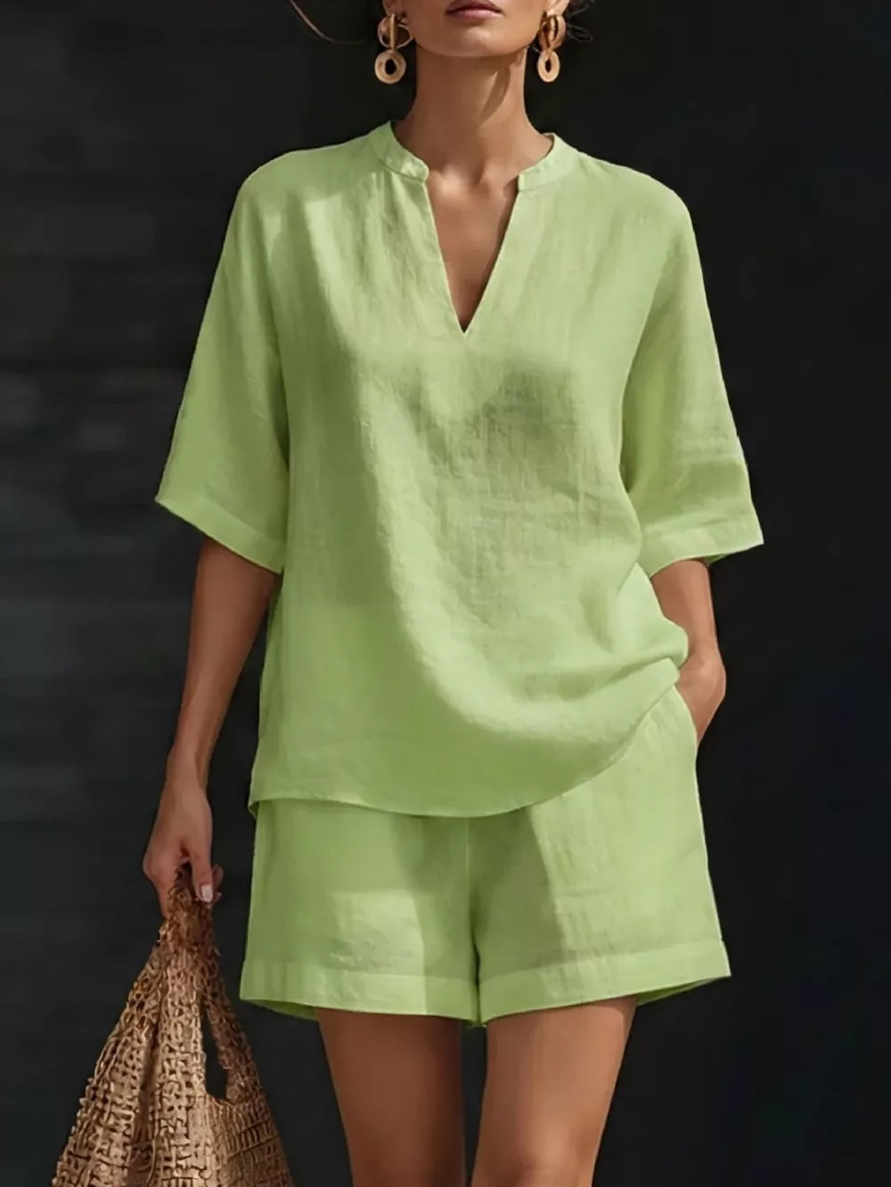 Green notched V-neck two-piece set with shorts and pockets, comfortable casual outfit.
