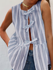 Light blue striped peplum top with bow tie closures and a ruffled hem.