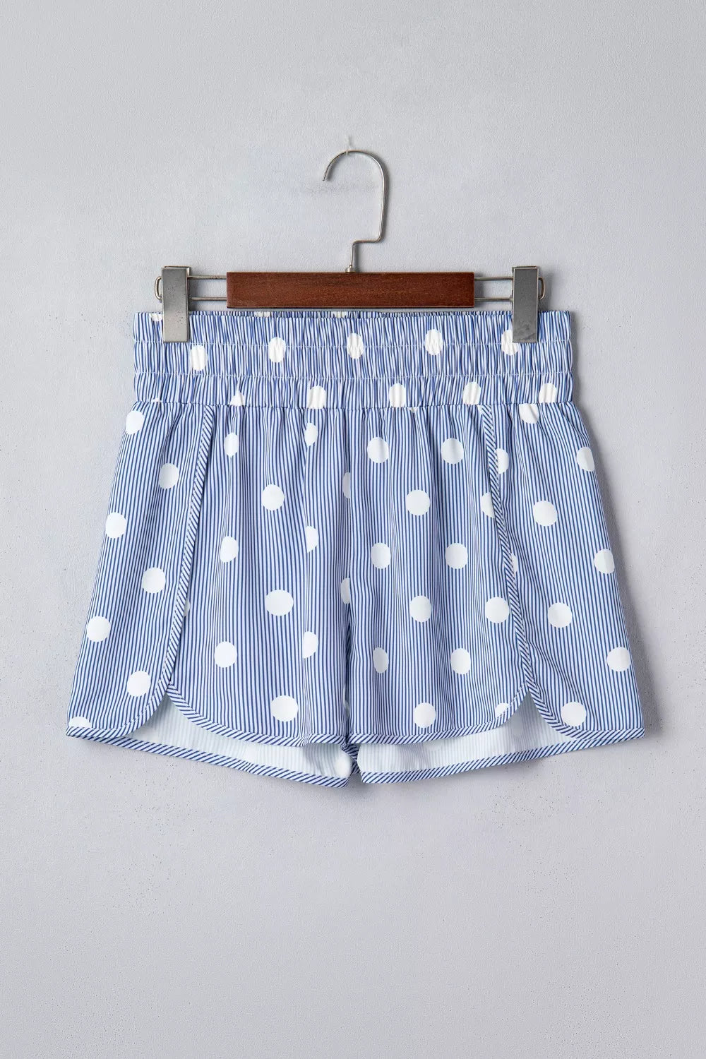 Blue and white polka dot striped shorts with elastic waist and side slits.
